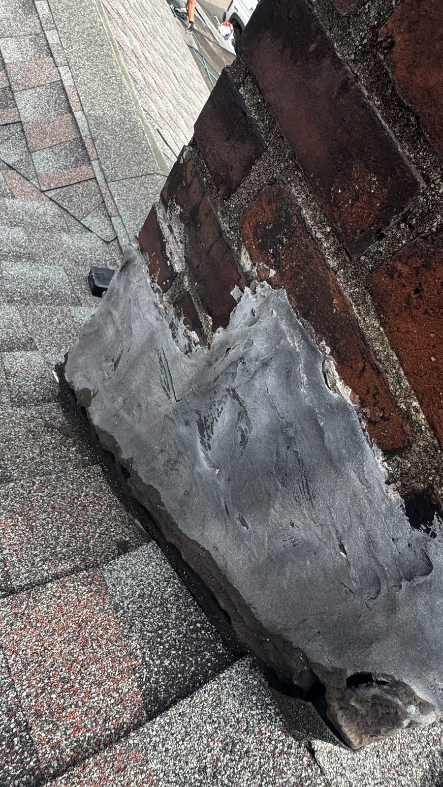 Failed chimney flashing sealed with roof cement in Cedar Knolls, New Jersey