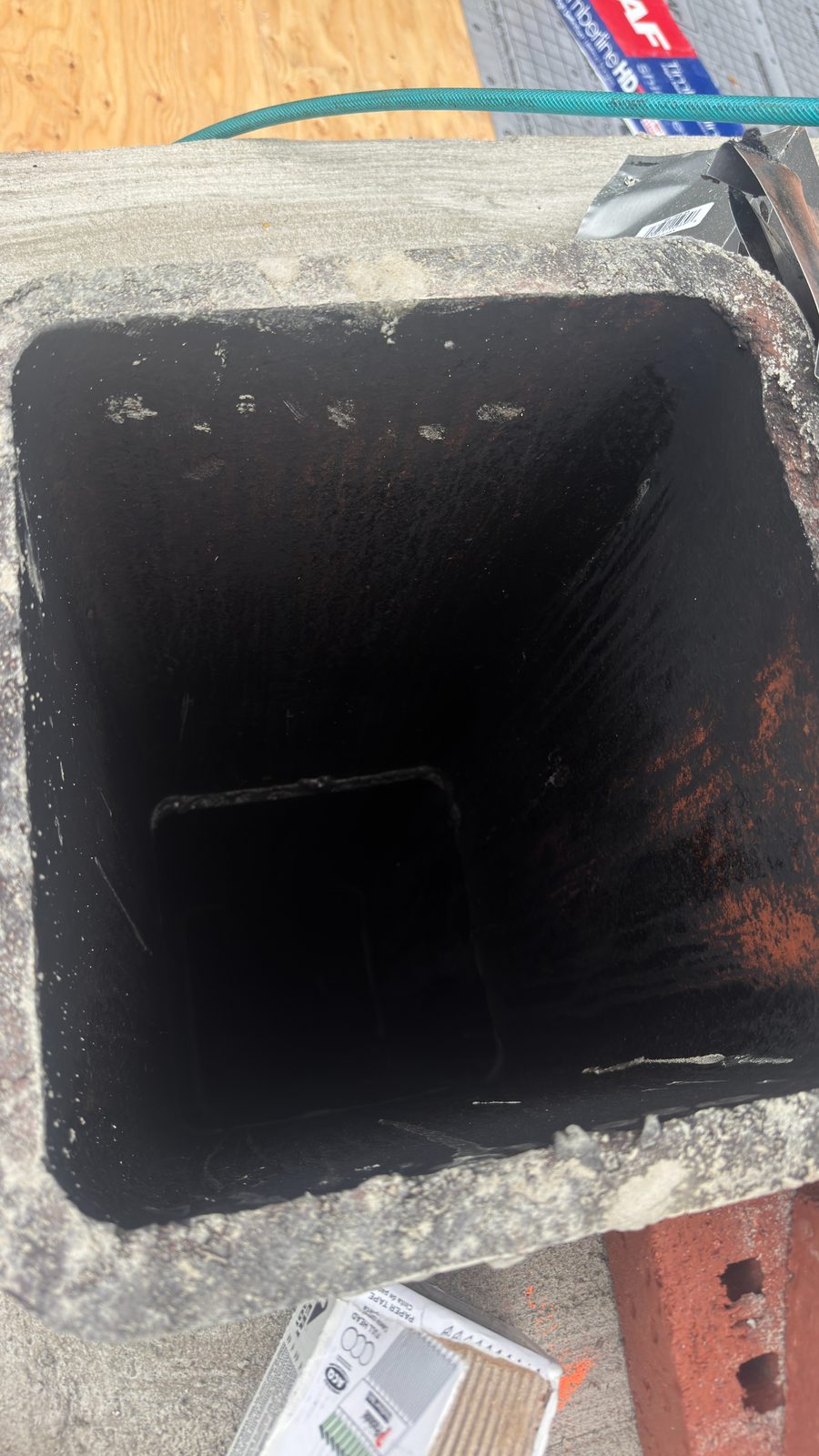 Looking down into a chimney flue from the crown during an inspection in Basking Ridge, New Jersey