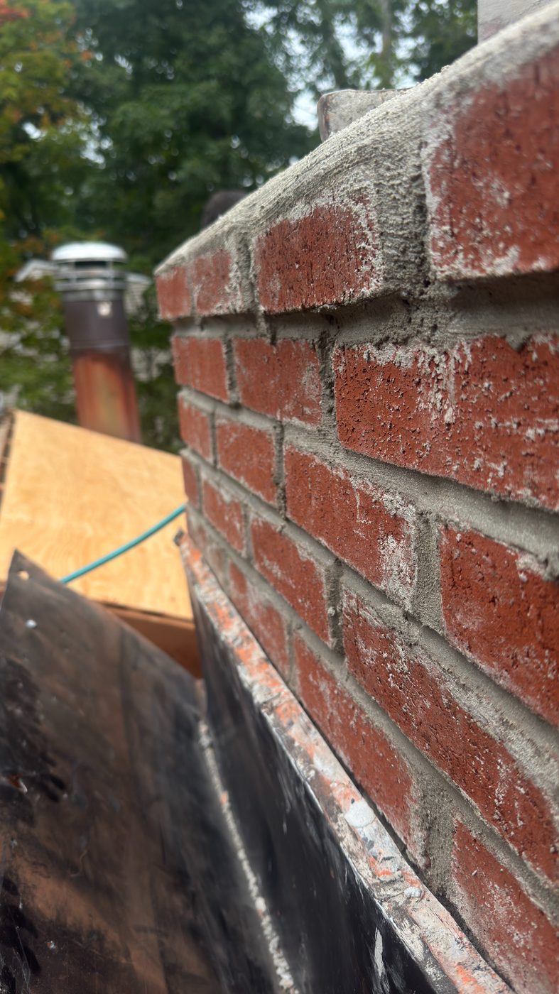 Rebuilt brick chimney with new crown and tight mortar joints