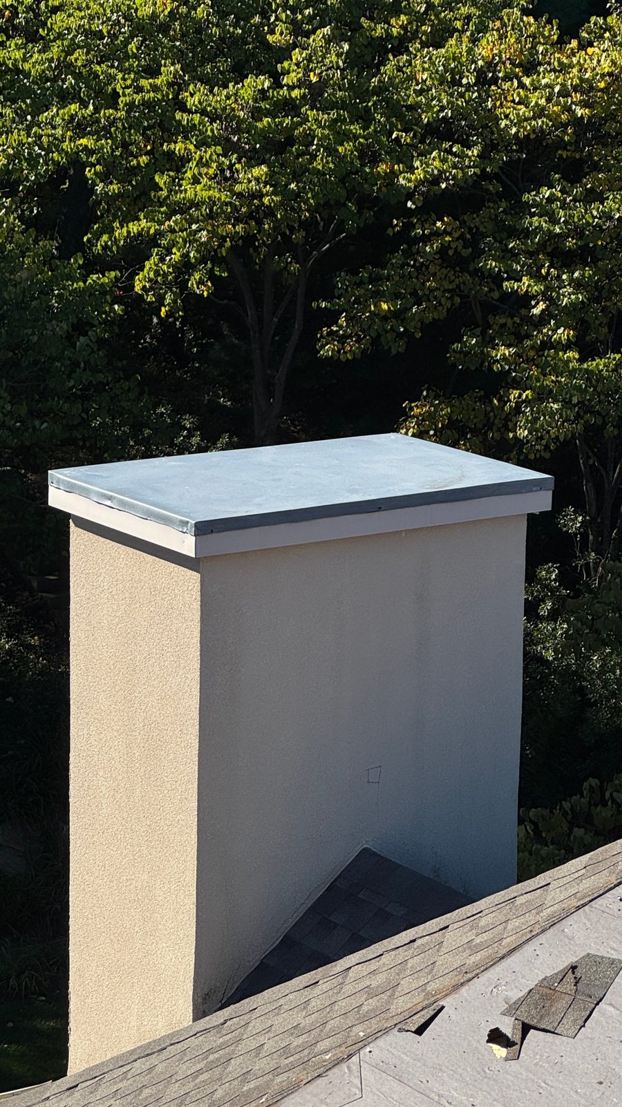 New metal chase cover on top of a stucco chimney in Bloomingdale, NJ