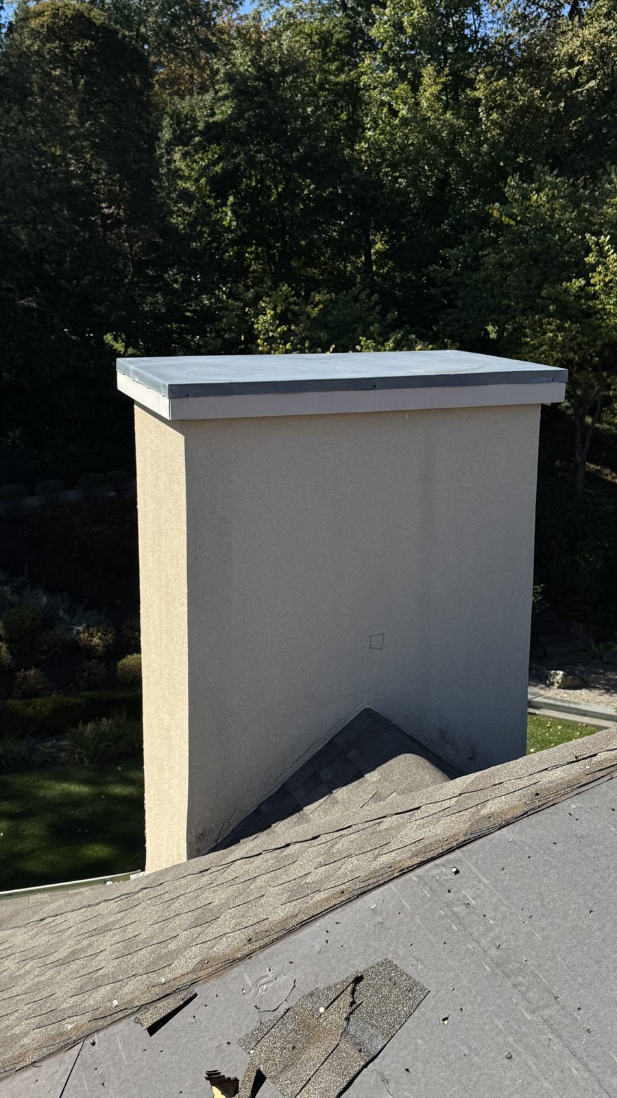 Stucco chimney in Towaco, NJ with a new metal chase cover installed on top by FlueRite