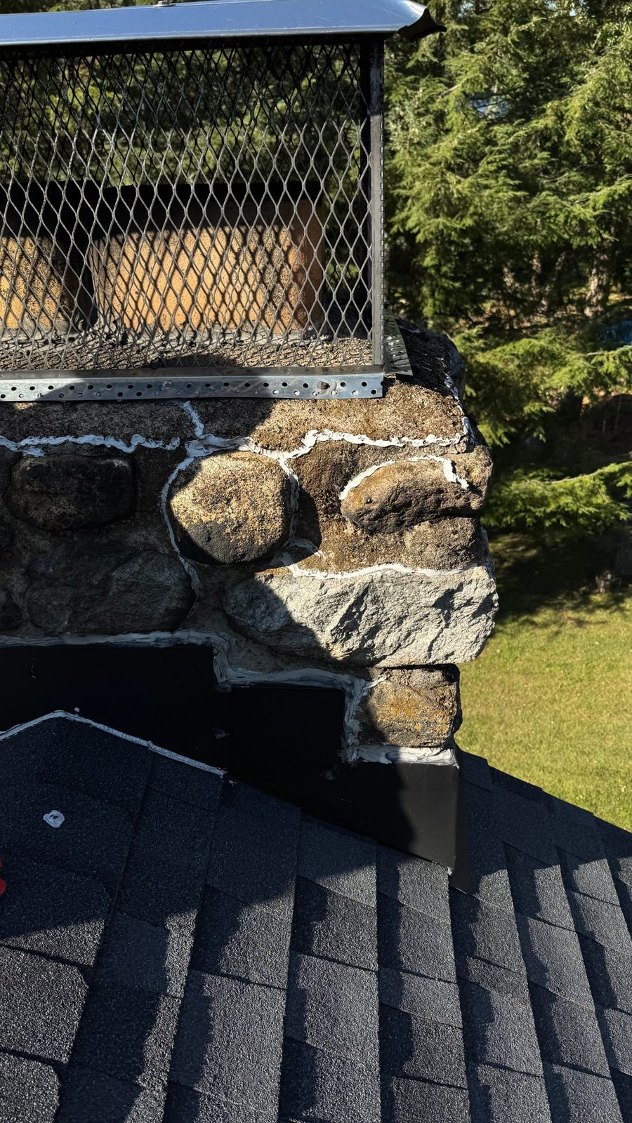 New chimney flashing stepped to follow the stone on a fieldstone chimney in Kinnelon, NJ