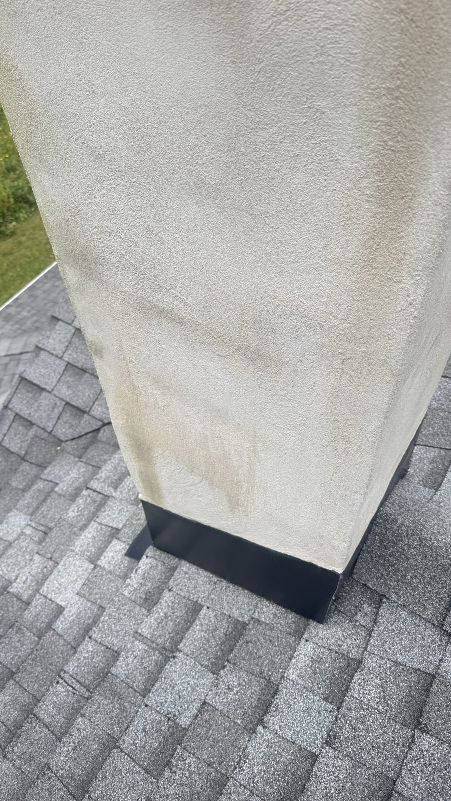 Chimney flashing at the roofline of a stucco chimney in Mountain Lakes, NJ, after flashing repair by FlueRite