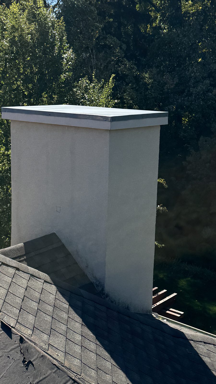 Second view of the stucco chimney in Towaco, NJ with its new metal top and repaired stucco at the roofline