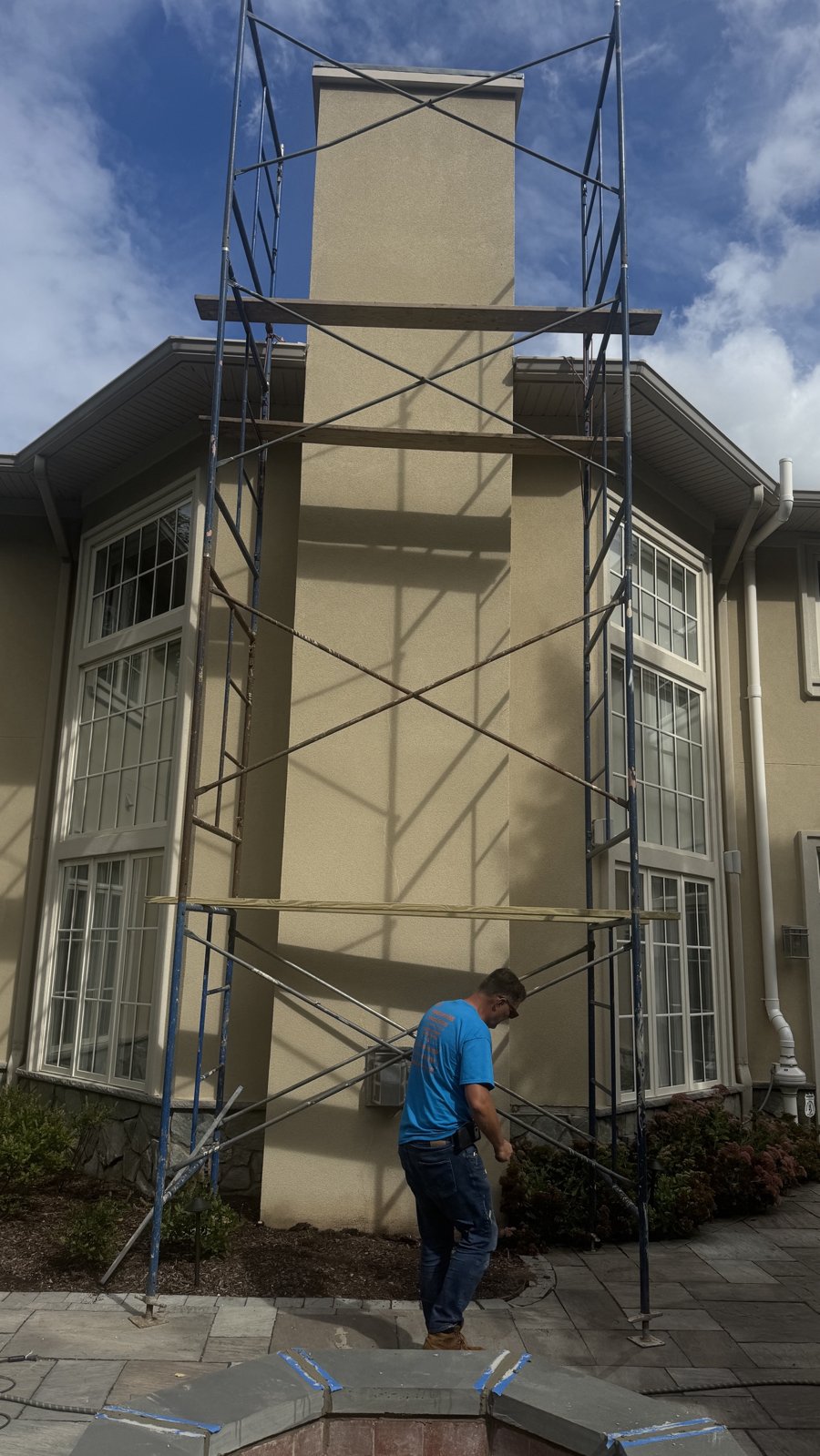 FlueRite crew setting up scaffolding for chimney and stucco repair on a two-story home in Montville, NJ