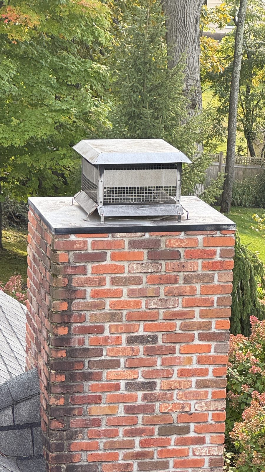 Brick chimney in Randolph, NJ before repointing, with weathered mortar joints and water staining