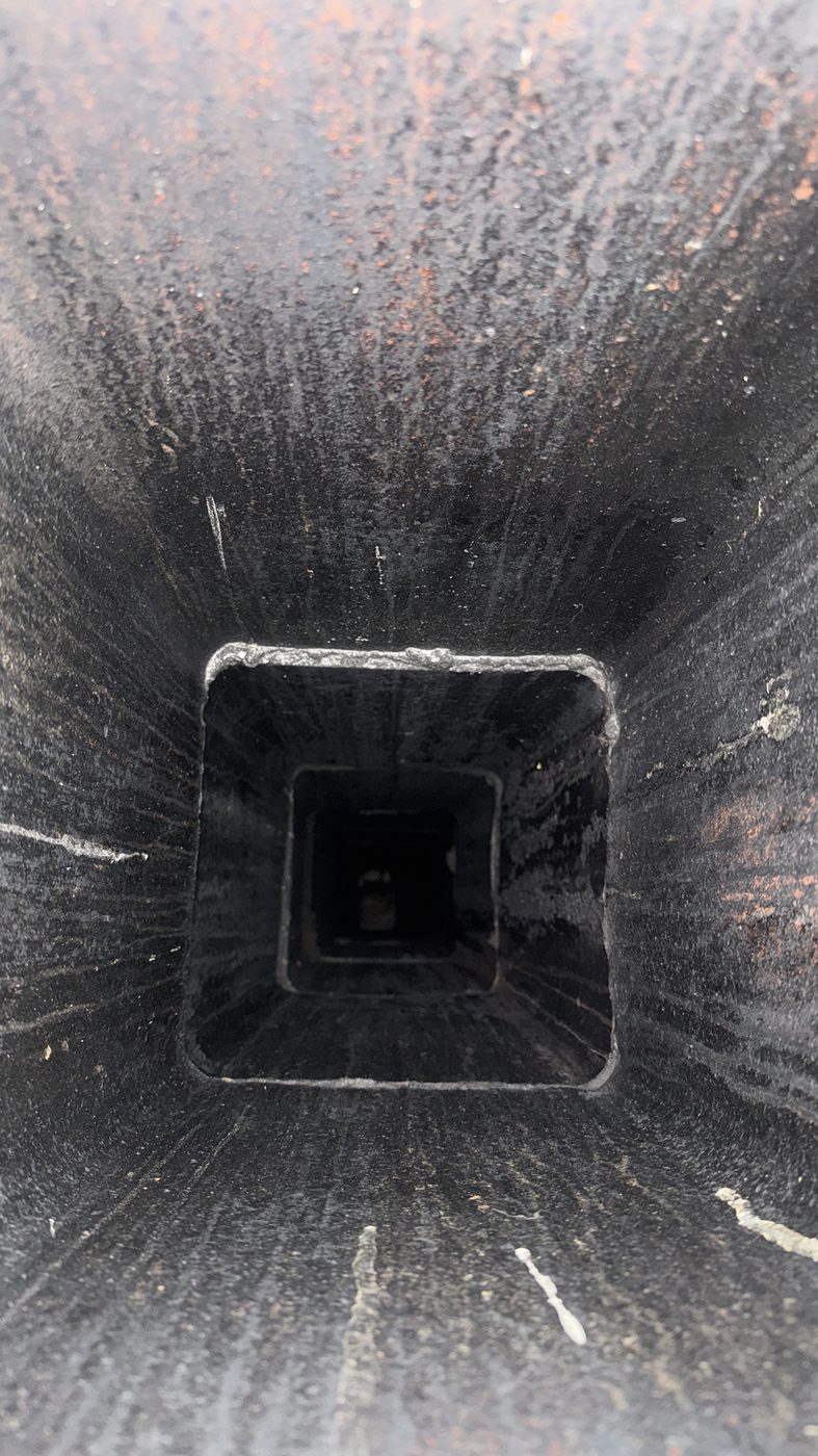 Heavy creosote and soot buildup inside a chimney flue in North Jersey