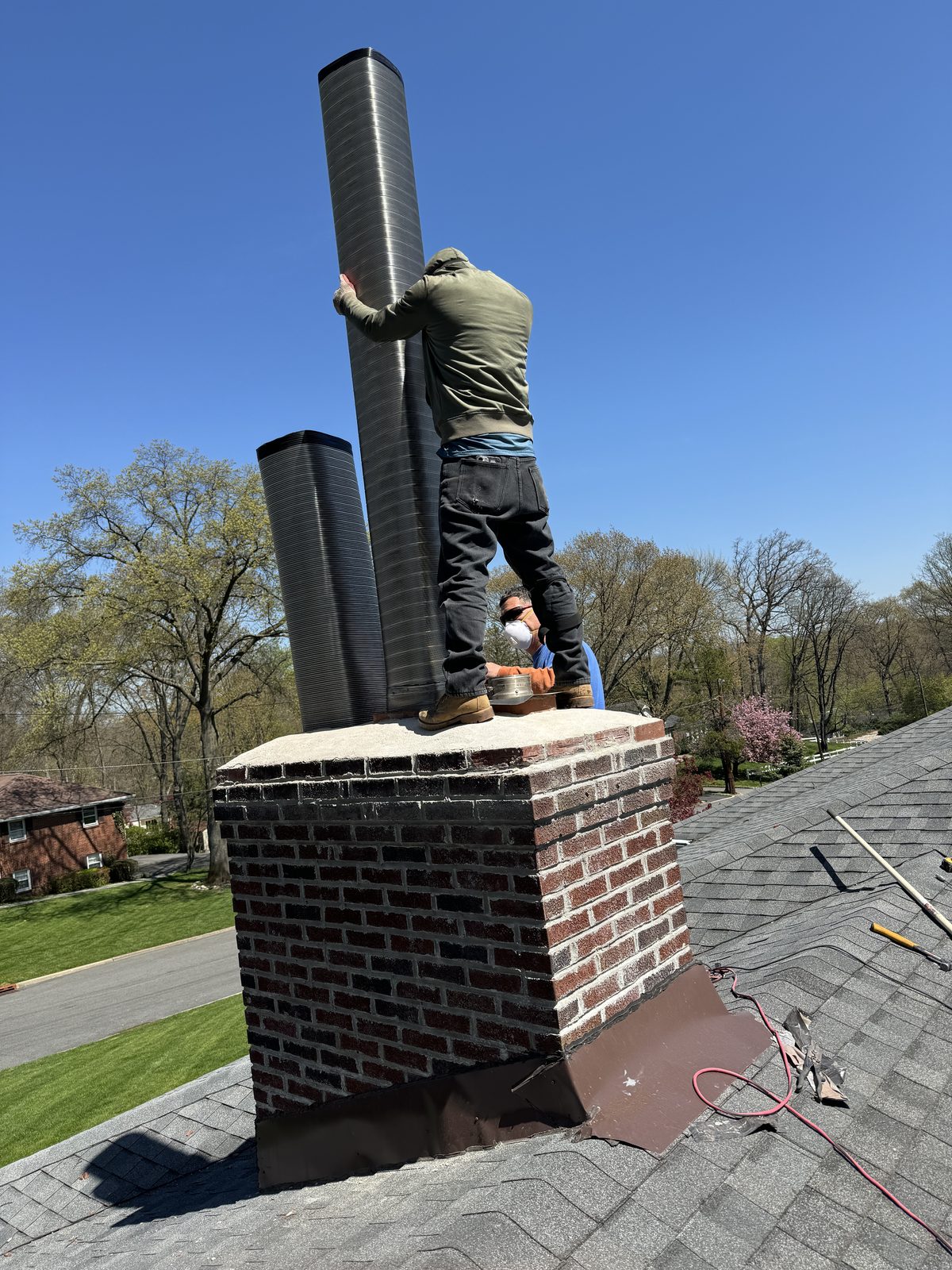 FlueRite crew installing a stainless steel chimney liner on a Chester NJ home