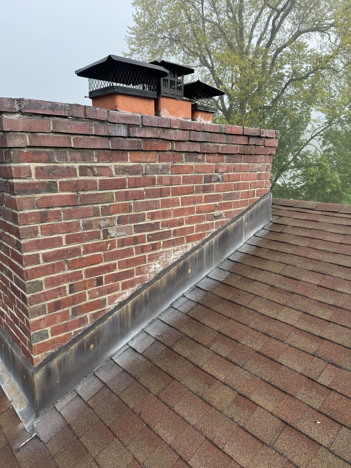 Multi-flue masonry chimney with new caps and flashing on a Madison NJ home