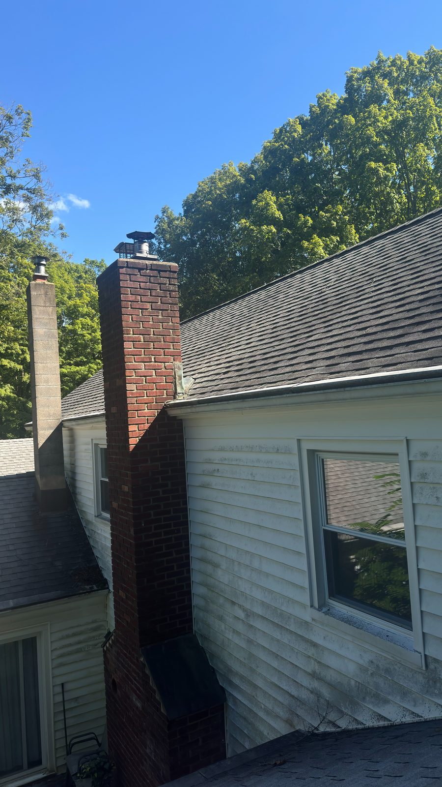 New stainless chimney caps installed on a two-flue chimney at a Mendham NJ home